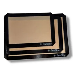 Non-stick silicone baking mats with a beige surface and black borders, branded \“finedine.\“