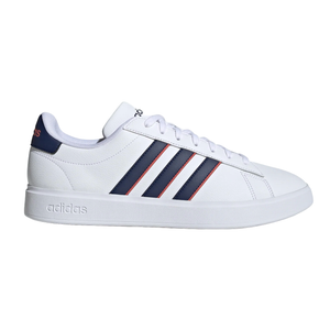 A white Adidas sneaker featuring three navy stripes with a red outline, white laces, and \“adidas\“ branding on the tongue and sole.