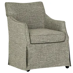 A gray upholstered armchair with a smooth, textured fabric, featuring a high back, cushioned seat, and armrests. The chair has a skirted base with a subtle split detail.