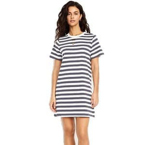A woman is wearing a short-sleeve, navy and white striped T-shirt dress.