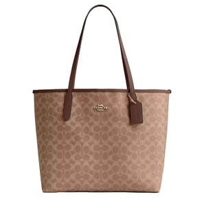 A Coach tote bag with signature brown C pattern, leather straps, and a Coach tag.
