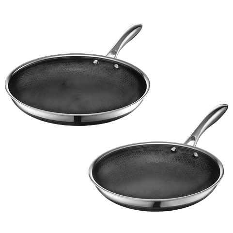 Two stainless steel frying pans with a textured, non-stick interior surface and ergonomic handles.