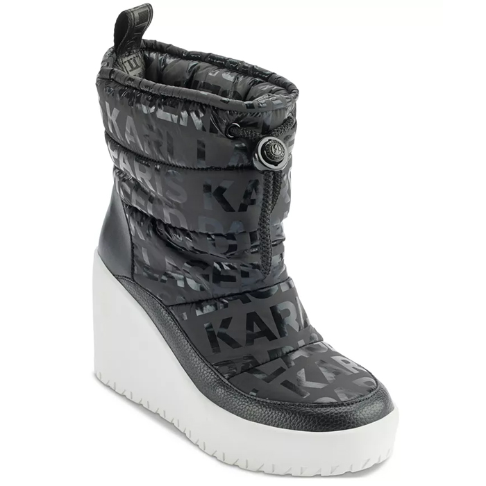 Black quilted snow booties with \“KARL\“ lettering, featuring a white wedge heel. They have a drawstring closure and textured detailing around the foot.
