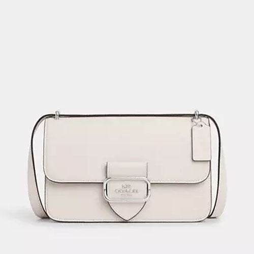 White shoulder bag with front flap and metallic clasp.