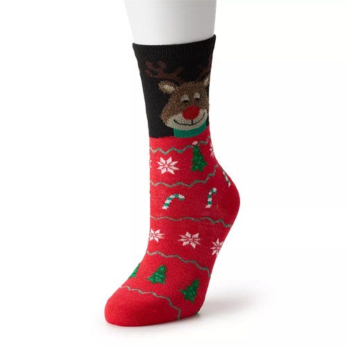 Red and black sock with a festive design featuring a reindeer on the upper part, along with candy canes, snowflakes, and Christmas trees on the lower part.