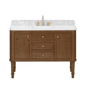 A wooden bathroom vanity with two side cabinets and three center drawers, featuring a white marble countertop and gold faucet hardware.