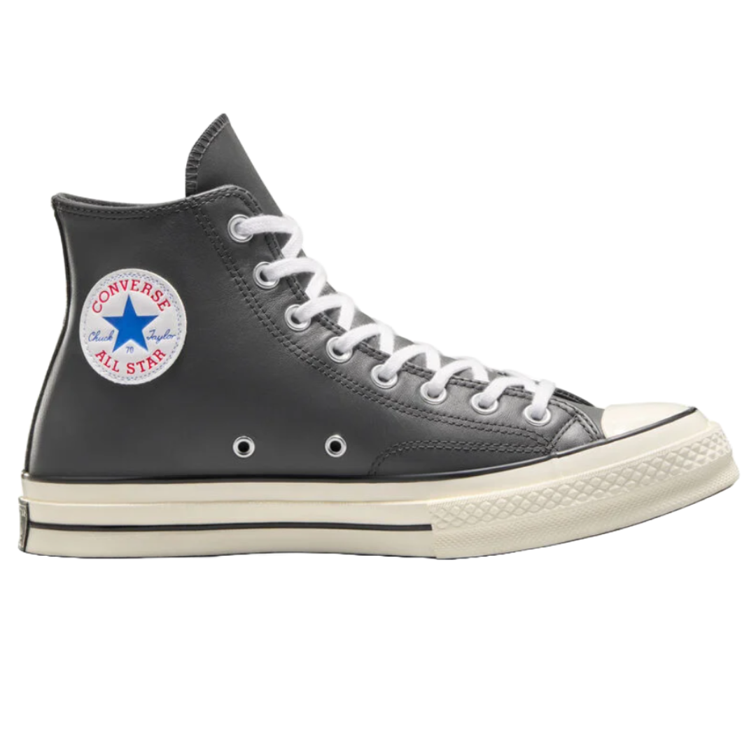 Black leather Converse Chuck Taylor All Star high-top sneakers with white laces, a white sole featuring a black stripe, and the classic circular logo patch on the ankle.