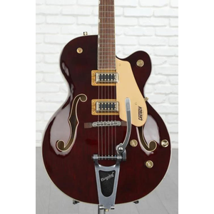 A hollow-body electric guitar with dual pickups, f-holes, and a Bigsby-style tremolo bridge.