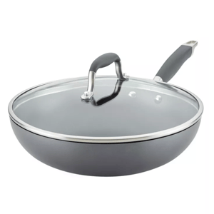 A deep skillet with a glass lid and a rubberized handle, featuring a sleek gray finish and metal rim.