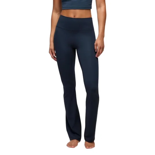 High-waisted, dark blue ribbed yoga pants with a bootcut design, worn by a barefoot model with a crop top.