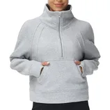 A person wears a gray, long-sleeve, half-zip pullover sweatshirt with a high collar and a kangaroo pocket.