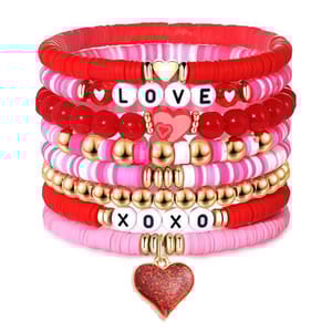 Valentine's Beaded Bracelet Set features multiple red, pink, and gold bracelets with bead designs spelling \“LOVE\“ and \“XOXO,\“ including heart accents and a hanging heart charm.