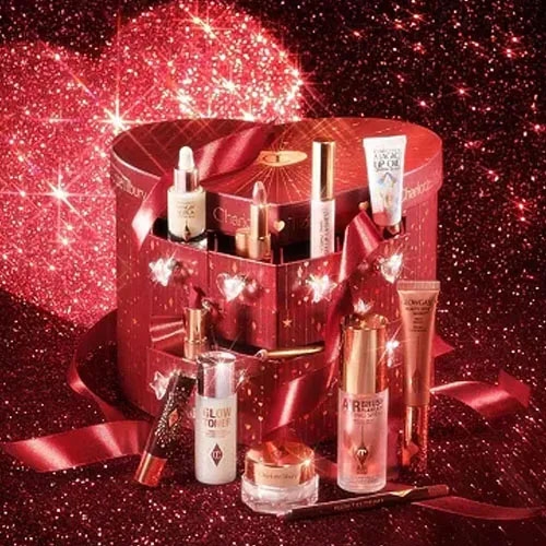 a heart shaped beauty advent calendar on a red glitter background