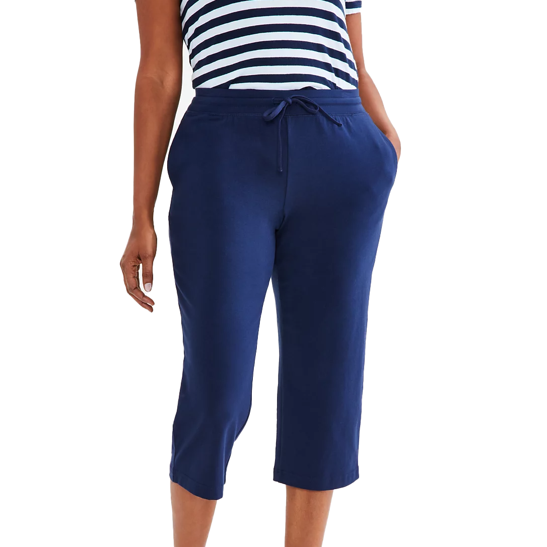 Navy blue Capri sweatpants with a relaxed fit, featuring an adjustable drawstring waistband and side pockets. Paired with a navy and white striped top, the sweatpants extend to mid-calf length.
