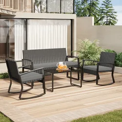 Outdoor patio set with black rattan design, including a two-seater bench, two armchairs, and a glass-top rectangular table, all with gray cushions; a pitcher with drinks is on the table.