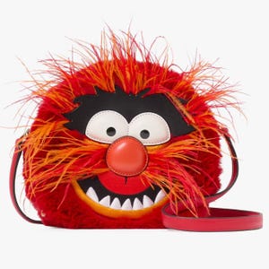 This is a red and orange fur-covered crossbody bag with a depiction of the character Animal from the Muppets, featuring prominent eyes, a large red nose, and a wide smiling mouth.