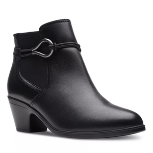 The Clarks Emily 2 Kaylie Dress Booties are sleek black ankle boots with a mid-height block heel and decorative strap detail featuring a silver metal loop. The boots have a smooth leather finish, offering a stylish and versatile look.