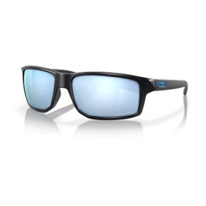 Oakley Gibston Polarized Sunglasses feature a sleek black rectangular frame with reflective blue lenses and a small blue logo on the temple, offering full coverage and glare reduction.