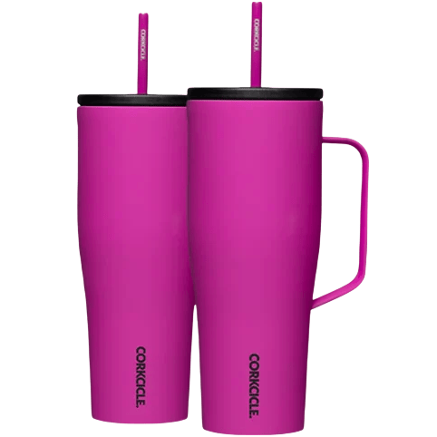 Two bright pink Corkcicle tumblers with black lids and matching straws, one featuring a handle.
