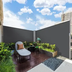 Retractable side awning, 236\“ x 63\“, provides privacy and wind protection on a patio. Features a sleek, modern design with a dark-colored fabric, complemented by a wooden deck and surrounding greenery.
