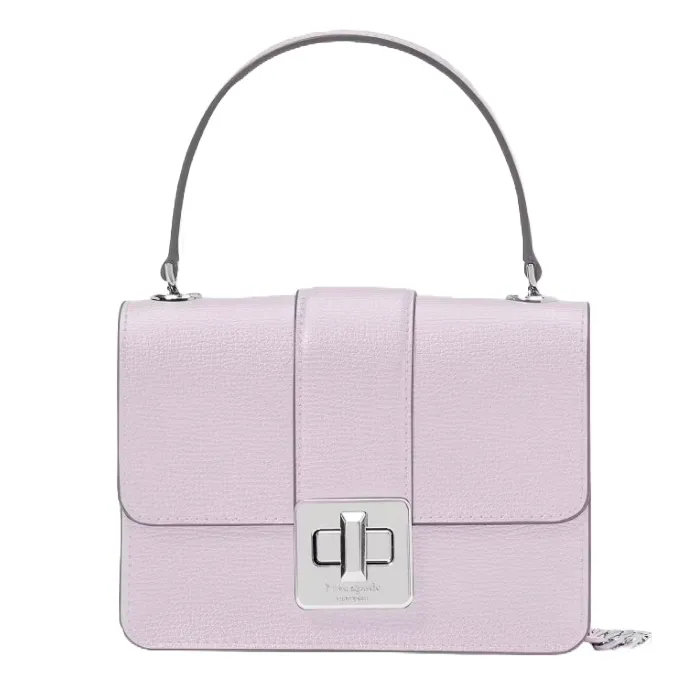 A lilac-colored handbag with a structured design, featuring a top handle and a rectangular silver turn-lock closure on the front flap.