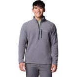 A man is wearing a grey Columbia fleece pullover with a quarter-zip and chest pocket.