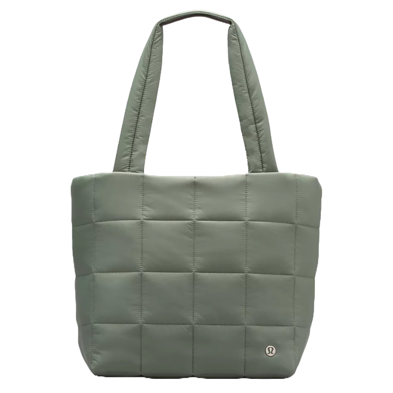 A green quilted tote bag with grid stitching and two shoulder straps, featuring a small logo emblem on the lower corner.