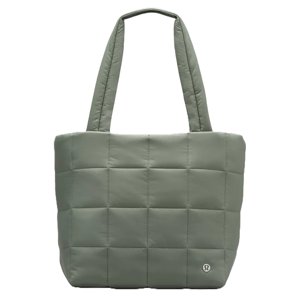 A green quilted tote bag with grid stitching and two shoulder straps, featuring a small logo emblem on the lower corner.