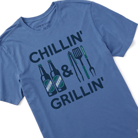 A blue men's t-shirt with the text \“CHILLIN' & GRILLIN'\“ and graphics of beer bottles and BBQ tools on the front.