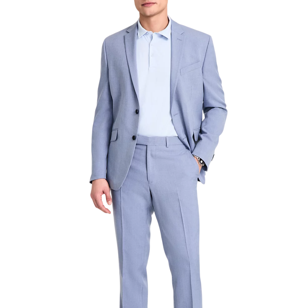 A man wears a light blue suit with a matching polo shirt and white sneakers. The outfit is sleek and modern, suitable for a smart-casual look.