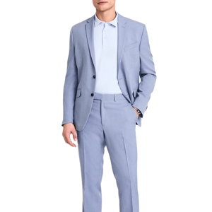 A man wears a light blue suit with a matching polo shirt and white sneakers. The outfit is sleek and modern, suitable for a smart-casual look.