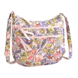 A shoulder bag featuring a vibrant floral pattern with daisies, poppies, and various flowers in pink, yellow, and purple hues. It includes adjustable straps and multiple zippered compartments.