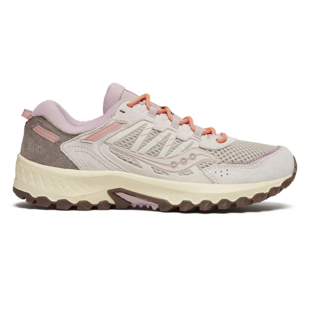 Trail running shoe with a beige and pink color scheme, featuring a mesh and suede upper, cushioned midsole, and rugged outsole for traction.
