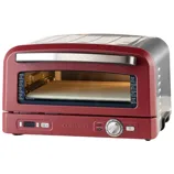 A Cuisinart countertop pizza oven in red with a glass window, digital display, and temperature control knob.