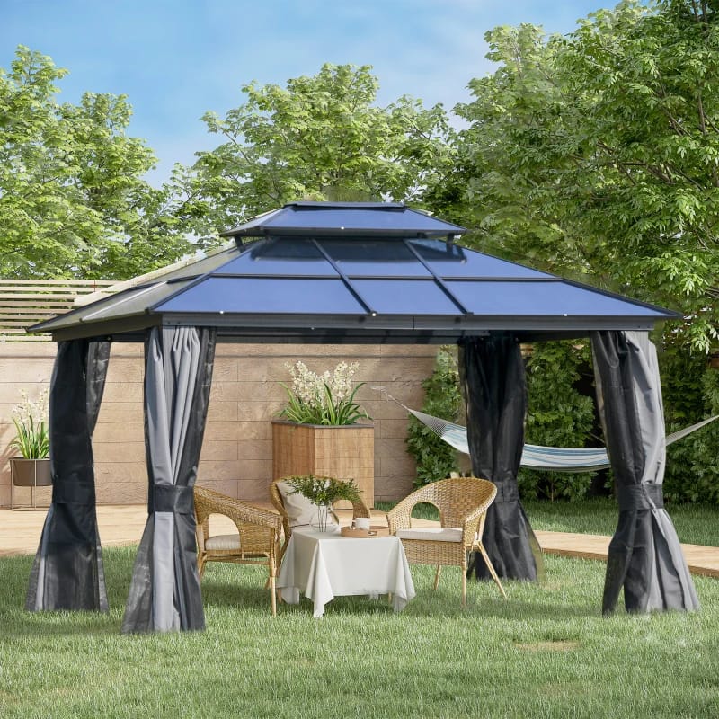 An outdoor metal gazebo with a fabric roof and curtains set on a lawn, accompanied by a table, chairs, and planters.