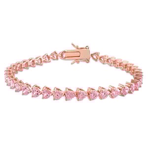 A bracelet with pink sapphire stones set in a rose gold-tone metal, featuring heart-shaped gems linked together with a secure clasp.