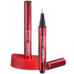 Two red Colgate Optic White Overnight teeth whitening pens with a stand.