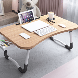Portable laptop desk with adjustable legs, equipped with a tablet holder, cup slot, and space for a notebook, keyboard, smartphone, and writing utensils.