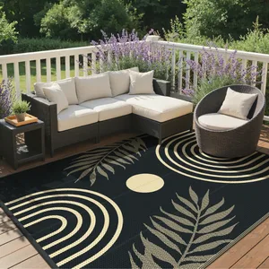 Outdoor patio with a wicker sectional sofa and round chair, featuring cushioned seats, surrounded by lavender plants. A stylish black and cream rug with leaf and circle patterns covers the deck.