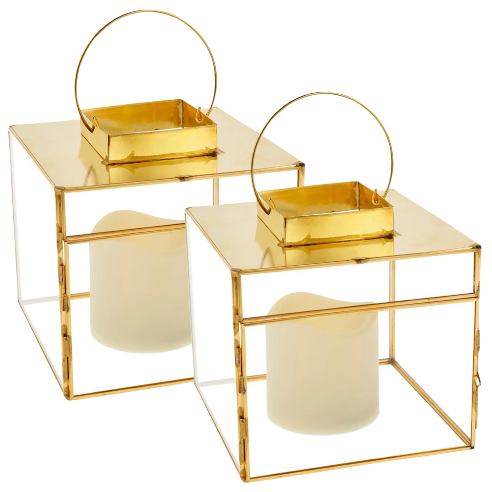 A pair of square glass lanterns with LED candles, featuring a gold metal frame and handle, measuring 6\“ x 6\“ x 6\“.
