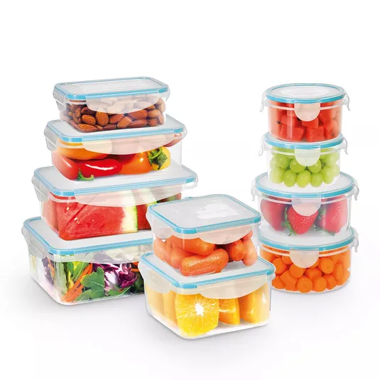 A set of transparent, airtight plastic food storage containers in various shapes, filled with items like almonds, carrots, strawberries, oranges, grapes, peppers, watermelon, and salad greens.