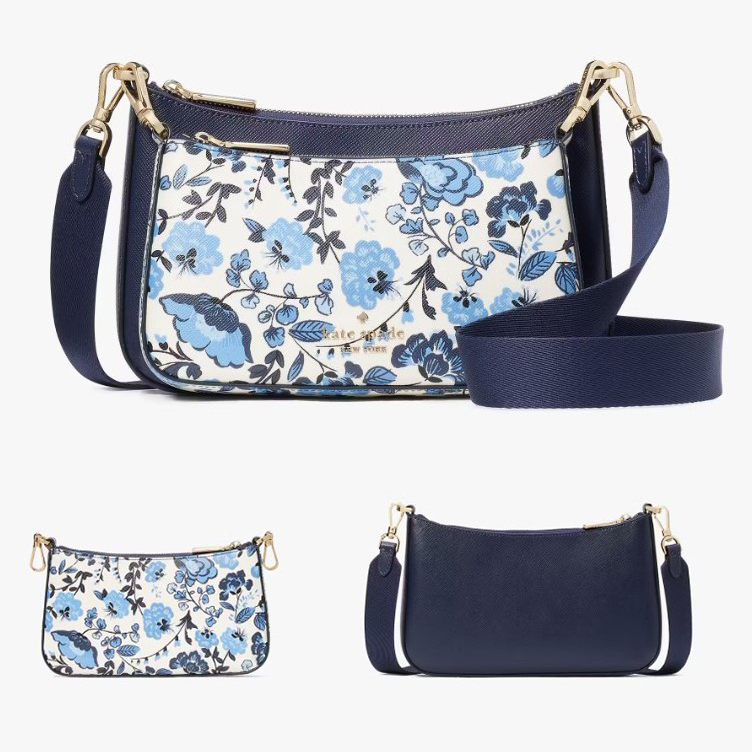 A blue floral-print crossbody bag alongside its plain navy version, both with adjustable straps.