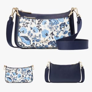 A blue floral-print crossbody bag alongside its plain navy version, both with adjustable straps.