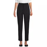 A pair of black, high-waisted straight-leg trousers paired with a white blouse and black shoes.