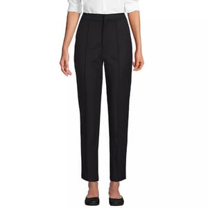A pair of black, high-waisted straight-leg trousers paired with a white blouse and black shoes.