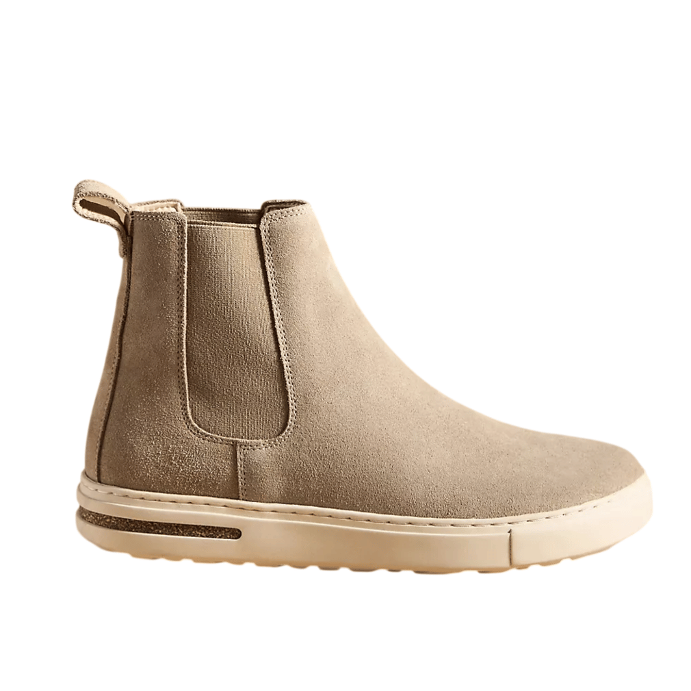 Beige suede Chelsea boot with a white rubber sole and elastic side panels for easy slip-on.