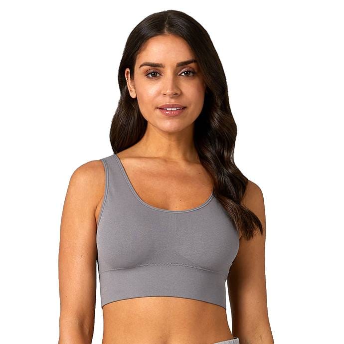 A woman wears a gray crop top with a scoop neckline and wide shoulder straps, suitable for casual or athletic wear.