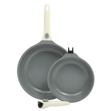 Two non-stick frying pans with gray interiors and white handles, one of which is detachable.