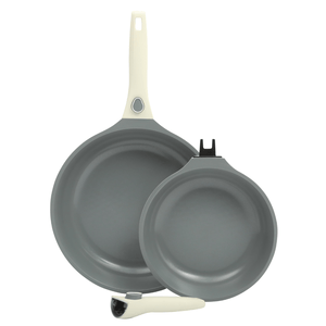 Two non-stick frying pans with gray interiors and white handles, one of which is detachable.