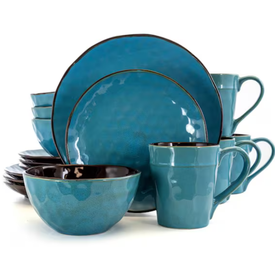 A 16-piece dinnerware set in glossy blue ceramic with a subtle textured finish, featuring plates, bowls, and mugs.